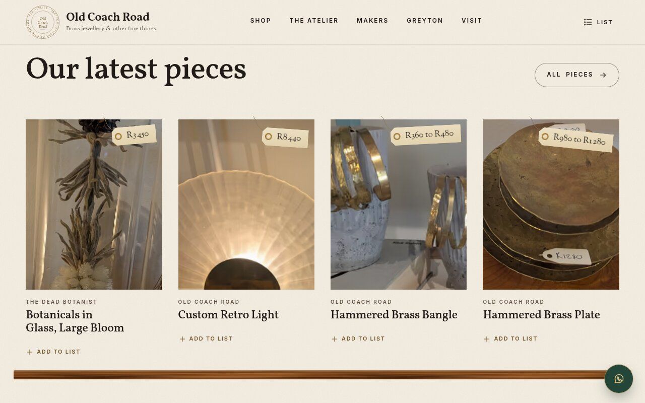 Our latest pieces shelf with price tags on botanicals in glass, a retro light, a brass bangle and a brass plate