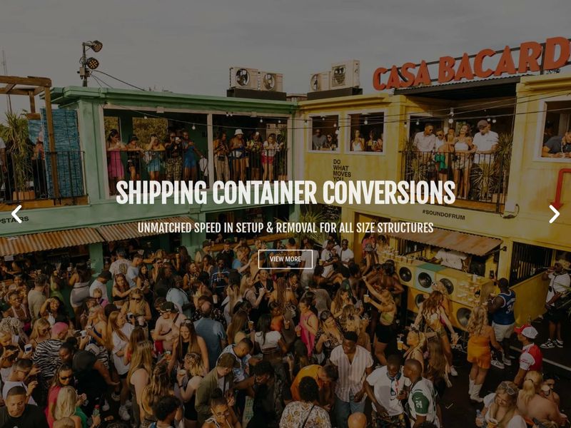 Shipping container conversions slide over a packed two-storey container bar with a View More button
