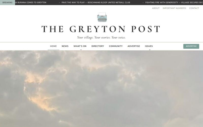 Newspaper masthead with typewriter logo and section navigation above a cloudy sky hero image