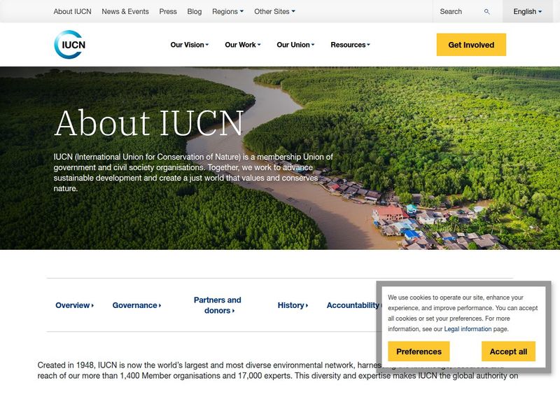 About IUCN page over an aerial mangrove river and village, with section links